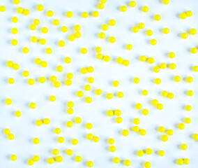 Round yellow vitamin C tablets on a white background.