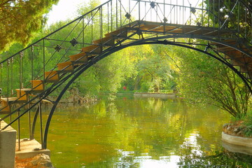 bridge over the  the river in spring with a beautiful and sparkling stream of water, pond, river, lake, shinning, green