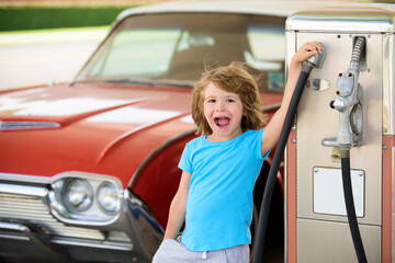 Kid fueling retro car at gas station. Refuel fill up with petrol gasoline. Petrol pump filling fuel...