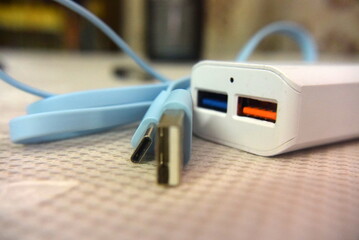 mint blue charging wire and power adapter macro. power for your smartphone