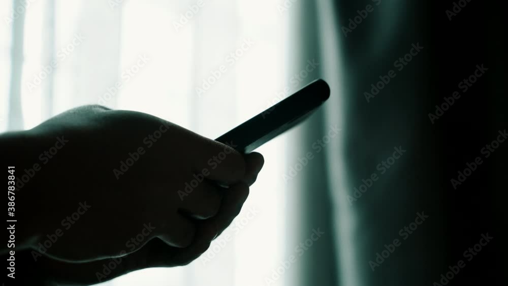 Poster man using smartphone at home with window background, hand typing message for online dating or shoppi