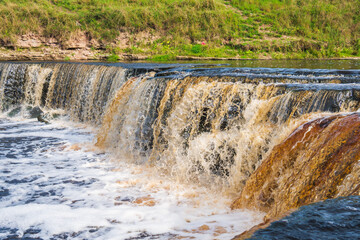 A stormy river with a brown hue.