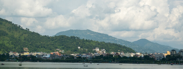 View of the Lakeside area in Pokhara city, Nepal, with the surrounding hills and Phewa Lake