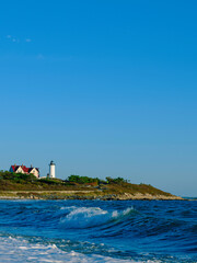 Nobska Lighthouse over the Sea Waves of Vineyard Sound in Woods Hole on Cape Cod