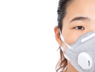 A lady wearing a mask exposes half of her face in front of a white background