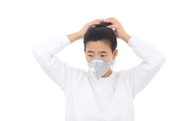 A lady wearing a mask is fixing her hair
