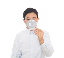 A man wearing a mask is checking a mercury thermometer