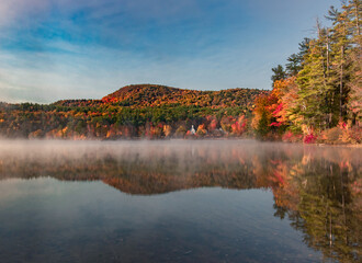 Fototapeta na wymiar Awesome reflection of autumn lake on a misty morning
