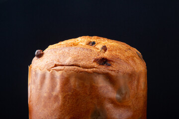 Panettone traditional Italian dessert for Christmas. Black background.