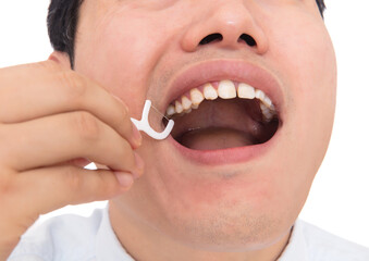 Close-up of man flossing teeth