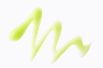 Green color cosmetic gel in abstract shape on background