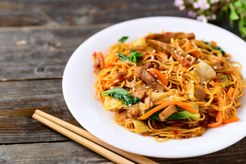 Asian food, vegetarian stir fried noodles with mushroom and vegetables