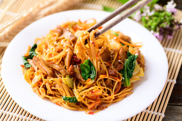 Asian food, vegetarian stir fried noodles with mushroom and vegetables