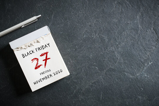 tear-off calendar with German message BLACK FRIDAY 27th NOVEMBER 2020 on slate background