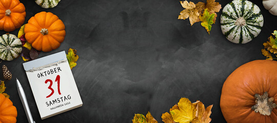 autumn decoration with pumpkins and colorful leaves and tear-off calendar with message OCTOBER 31st...