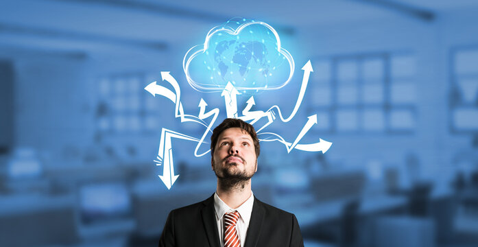 businessman interacting with a virtual cloud in front of an office background