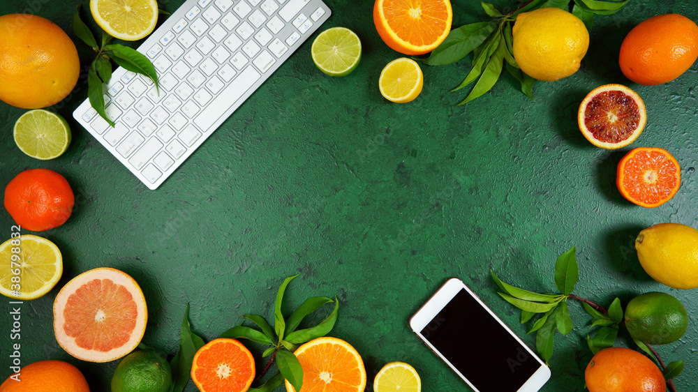 Wall mural health food theme background workspace with citrus fruit on dark green textured background. top view
