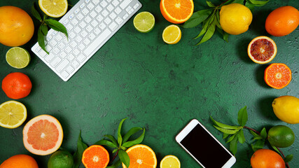 Health food theme background workspace with citrus fruit on dark green textured background. Top...