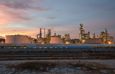 Industrial zone view, oil and gas refinery in sunset and dusk sky.