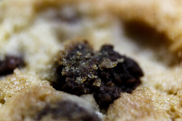 Macro 4k chocolate chip on a cookie. Sweets and Snacks. Sugar granules. Chocolate 4k. Diet and Nutrients. Yummy Treat. 