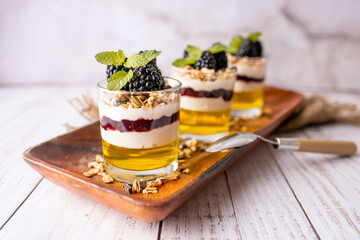 Dessert Parfait glass cup, with lemon jello, yogurt and fresh blackberries. 