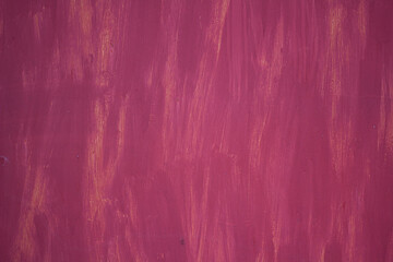 The texture of the metal surface is painted in pink-purple color with orange gaps. Background
