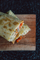 Top view of Delicious doner kebab wrapped in tortillas filled with chilli, meat, various vegetables and mayonnaise sauce