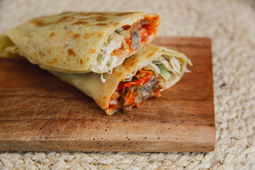 Delicious doner kebab wrapped in tortillas filled with chilli, meat, various vegetables and mayonnaise sauce