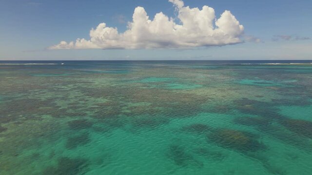 Relaxing slow moving aerial shot over coral on vacation in pacific ocean