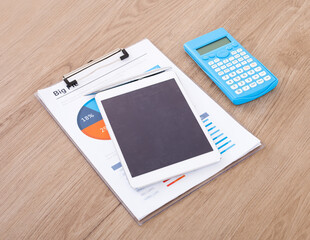 Documents and iPad and calculator on the desk