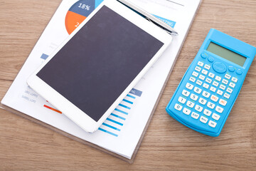 Documents and iPad and calculator on the desk