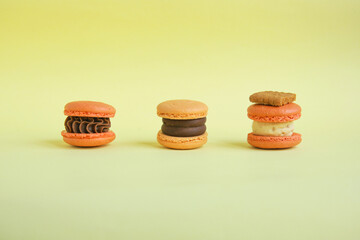 three colorful  korean macaroons on yellow background