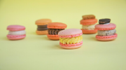 assortment colorful  korean macaroons on yellow background