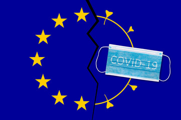 Protective face mask on Europe union flag with inscription Covid-19. Covid-19 outbreak around the world. The global economic crisis. Crash by coronavirus. Life in lockdown around the world