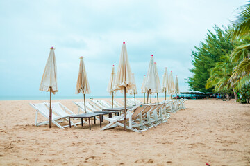 Beach chair and umbrella on the beach.
