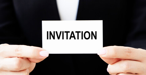 businessman holding a card with text INVITATION FOR TENDER