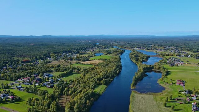 Picturesque Landscape Of Green Fields In Malung Near Vasterdal River On A Bright Day In Dalarna, Sweden. - aerial drone shot