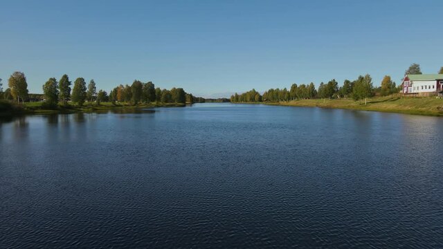 Drone Flying Under The Steel Bridge Spanning Across The Vasterdal River Near The Malung In Dalarna, Sweden. - aerial drone shot