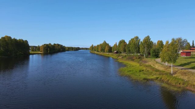 Flying Over The Calm Waters Of Vasterdal River Near Malung, Dalarna, Sweden. - aerial drone shot