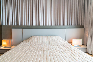 bed with bedspread in bedroom
