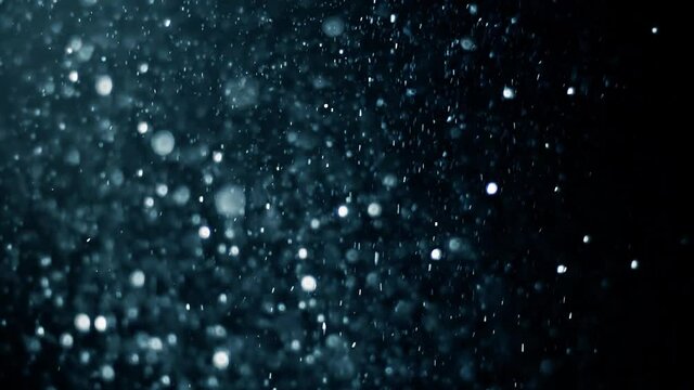 Gold dust particles fly in slow motion in the air lingering slowly. Dust Particles Background Bokeh Lights Background on Black Background 4k Footage Snow Particles Background.