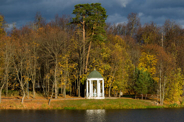 Park rotunda on the shore of the reservoir. Autumn in the Belkino estate park. Obninsk, Russia
