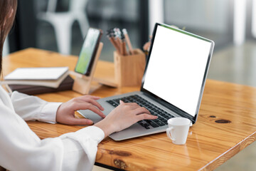 Mockup. Close up businesswoman typing on laptop with blank white screen.