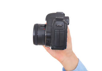 Hand holding black SLR camera close-up