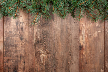 Christmas background with fir tree. Christmas tree branches on wooden texture ready for your design. Winter holidays background