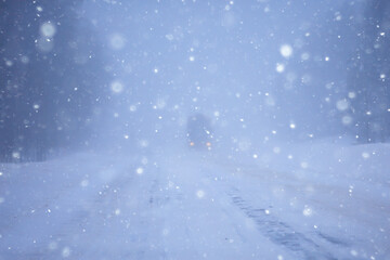 snow and fog on the winter road landscape / view of the seasonal weather a dangerous road, a winter lonely landscape