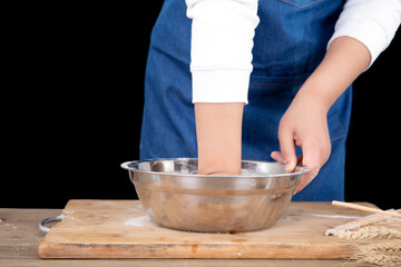 Close-up shot of hands kneading white dough in bowl