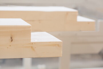 Wooden beam in sawn grooves. Woodworking machine products. Construction materials made of wood.