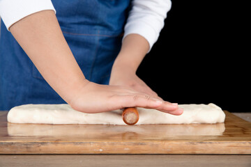 The chef rolled the long noodles into a cake