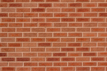 Full frame abstract view of a modern traditional brick wall background, with textured red and...